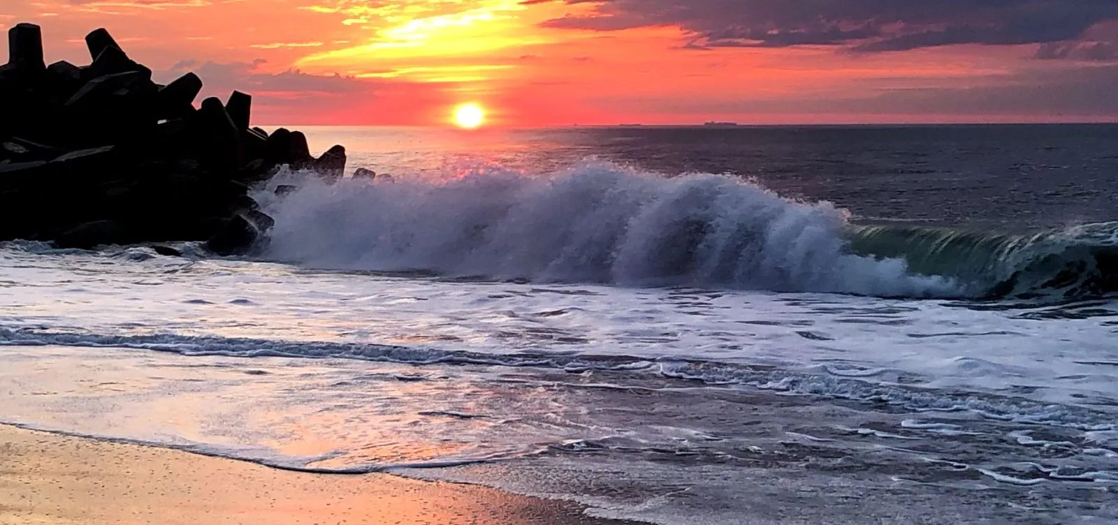 sunset on the beach with waves crashing
