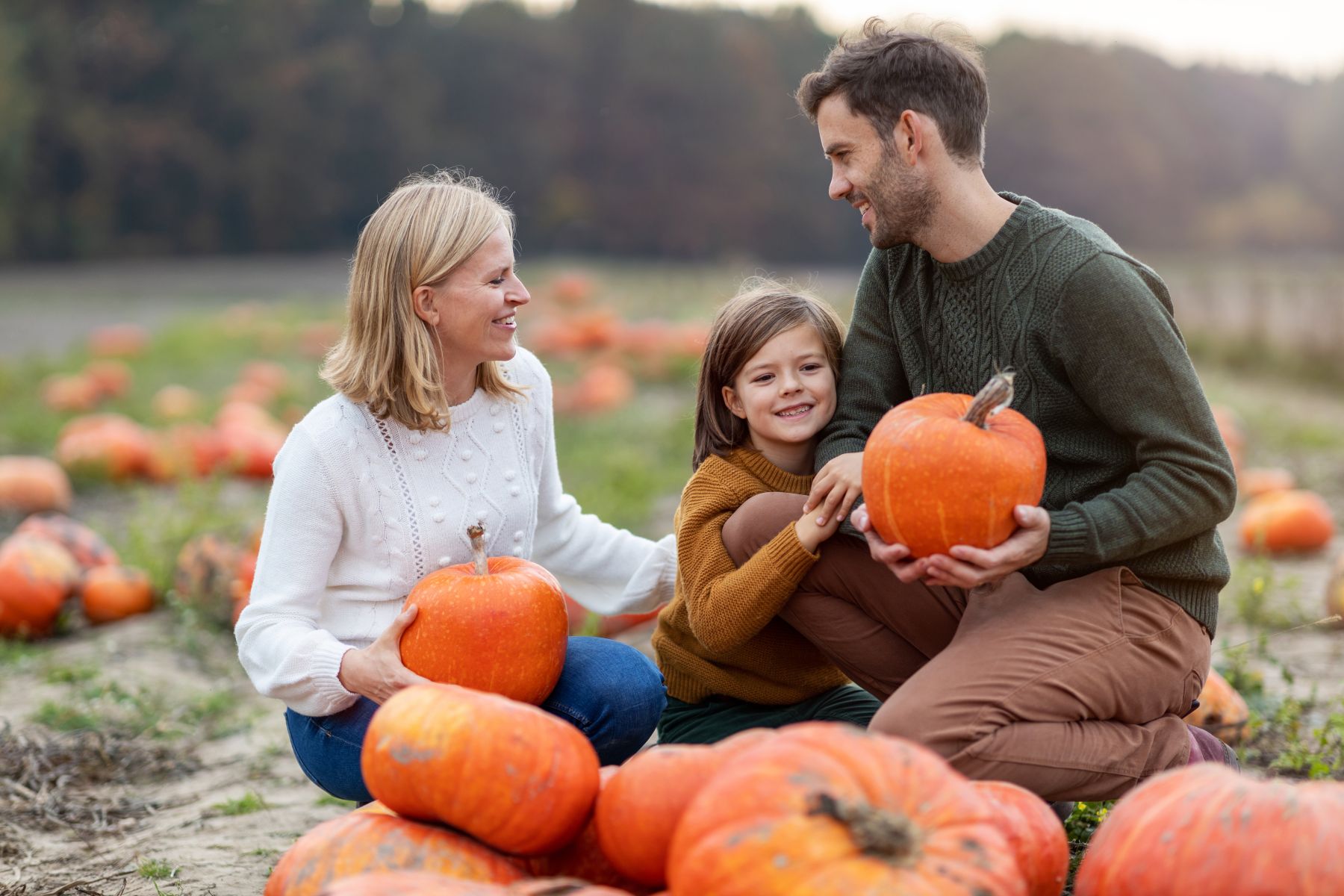 Family having fun at a pumpkin patch